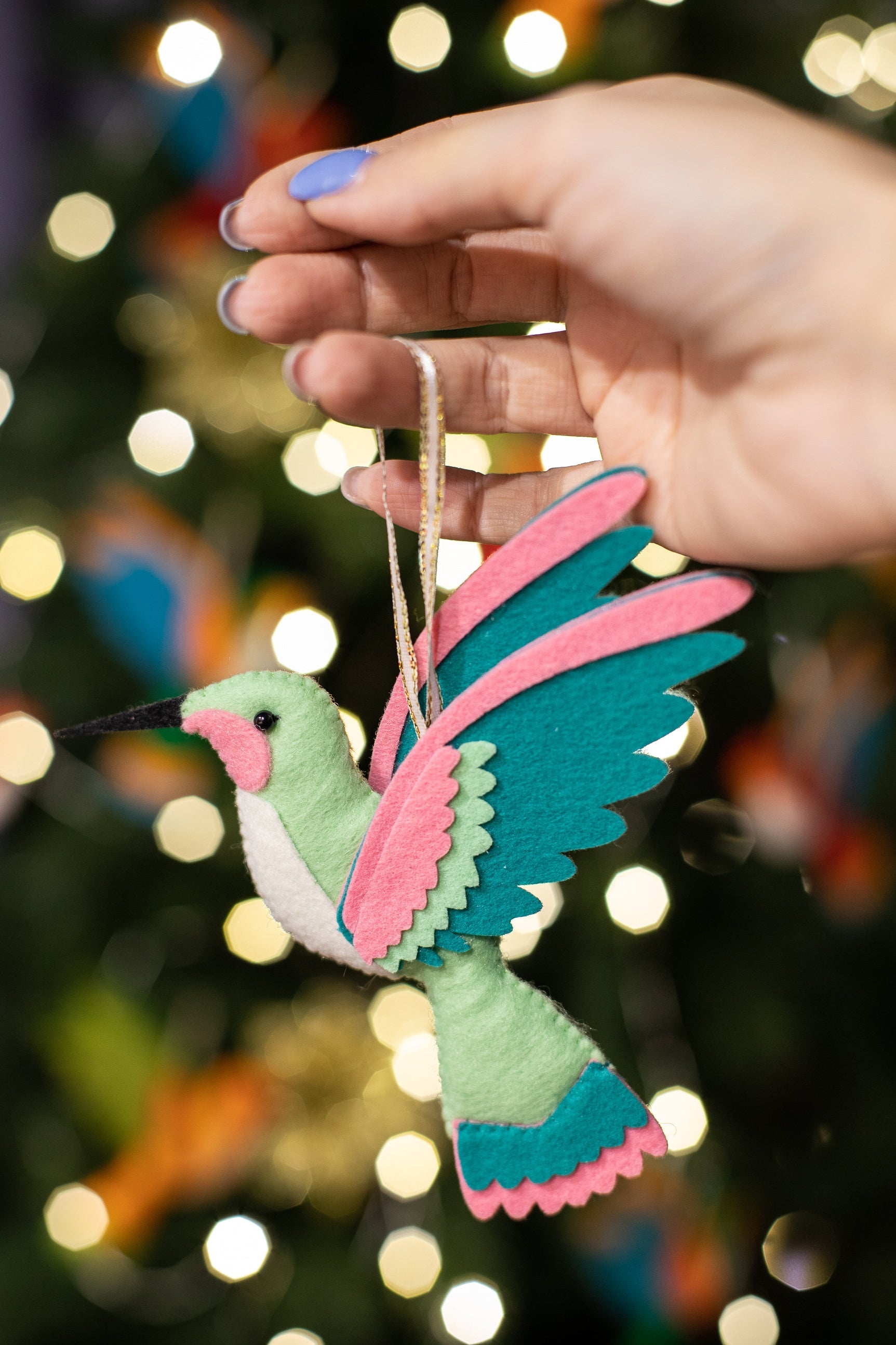 Handmade felt hummingbird ornaments with meent green color with light belly and teal wings. 