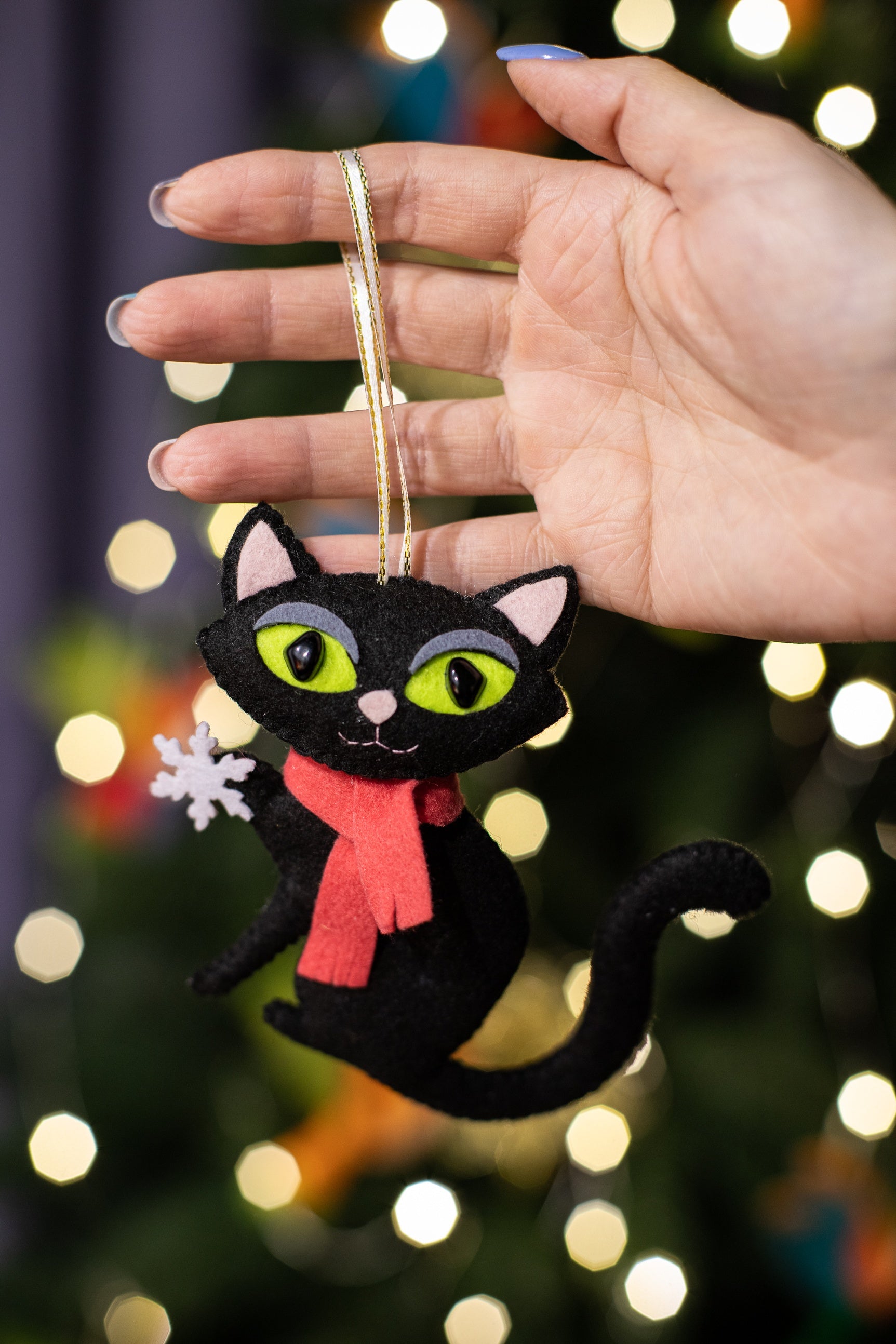 Felt black cat ornament, with big green eyes and der scarf