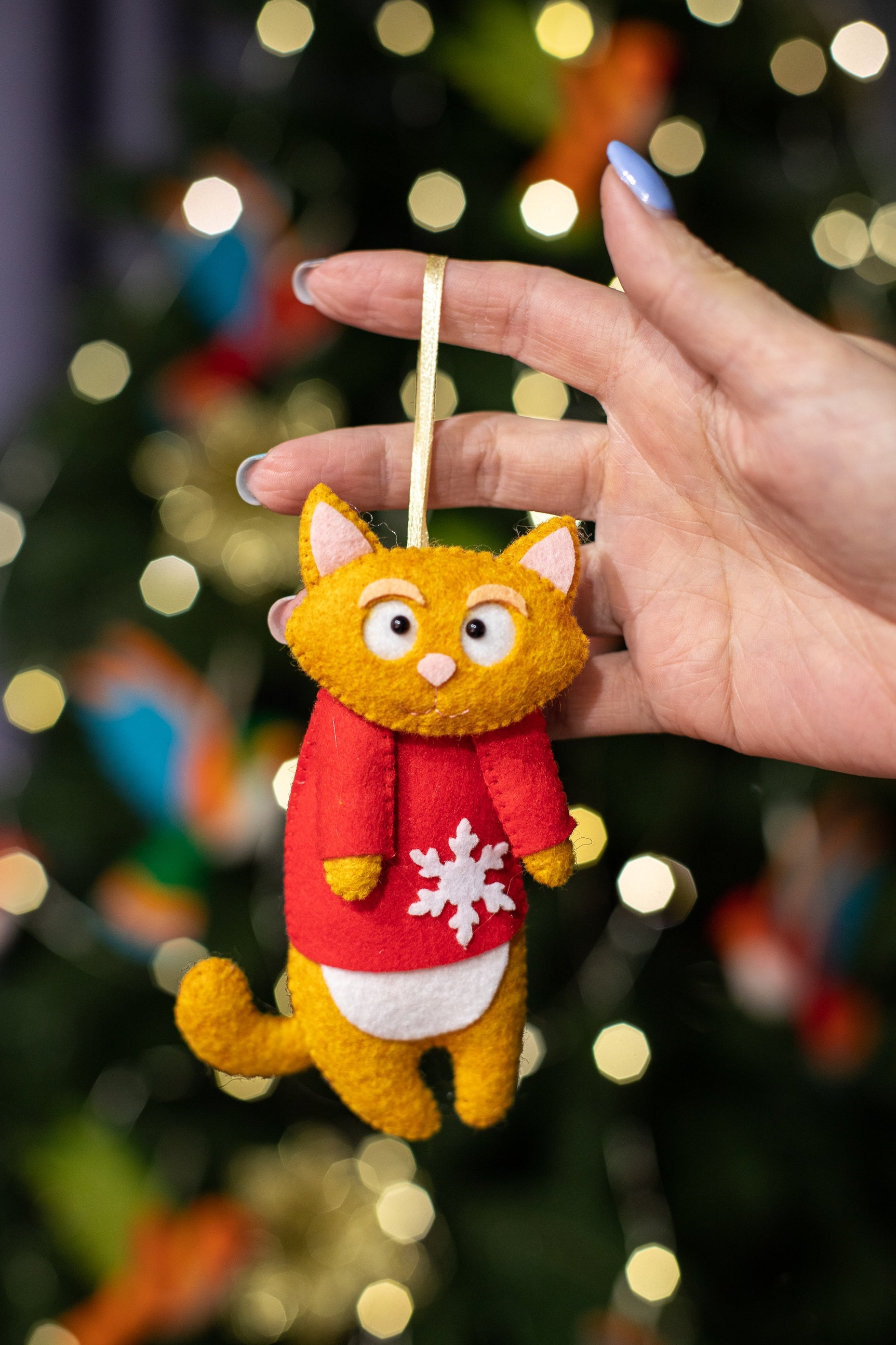 Felt cat ornaments wear in festive red sweater with a snowflake