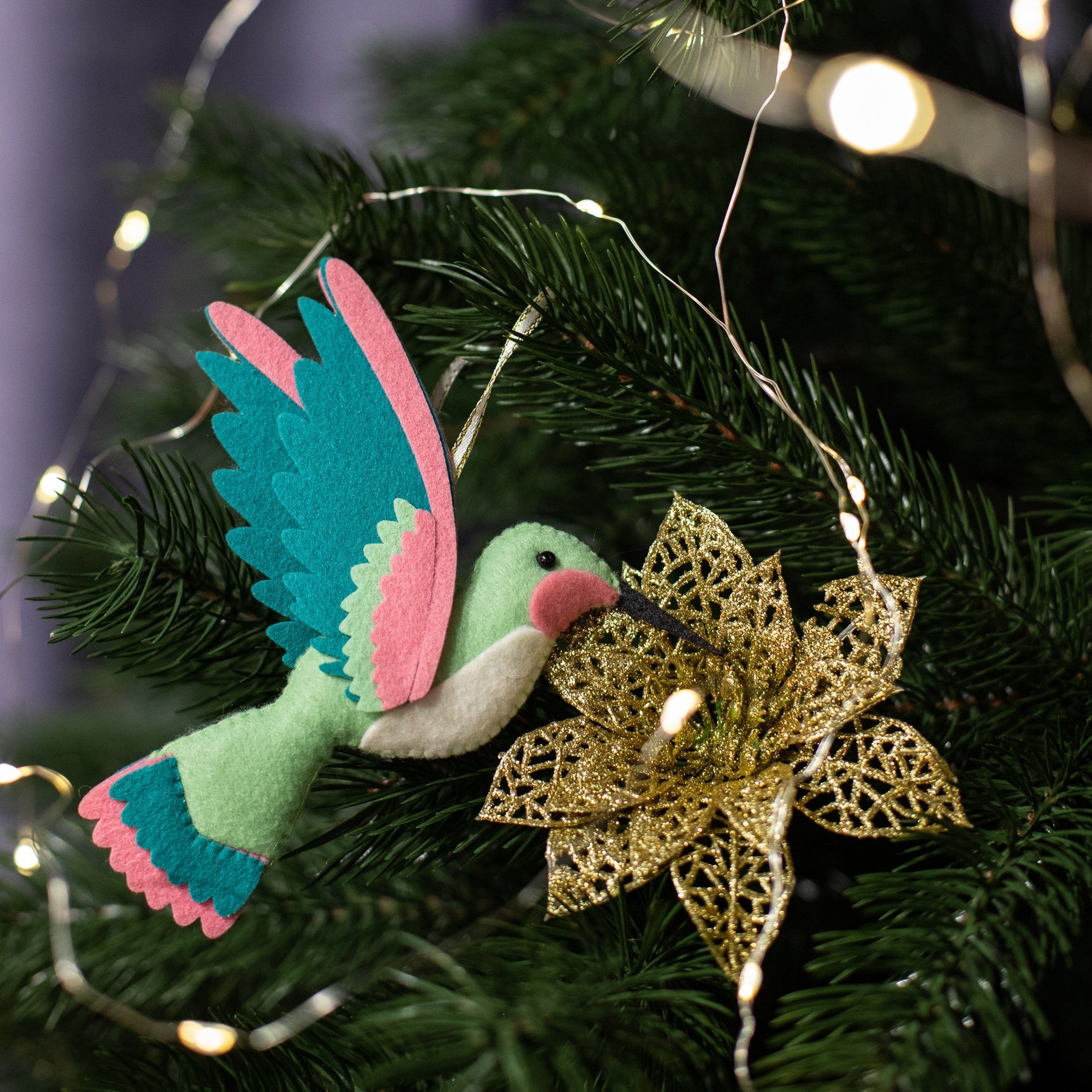 Handmade felt hummingbird ornaments with meent green color with light belly and teal wings. 