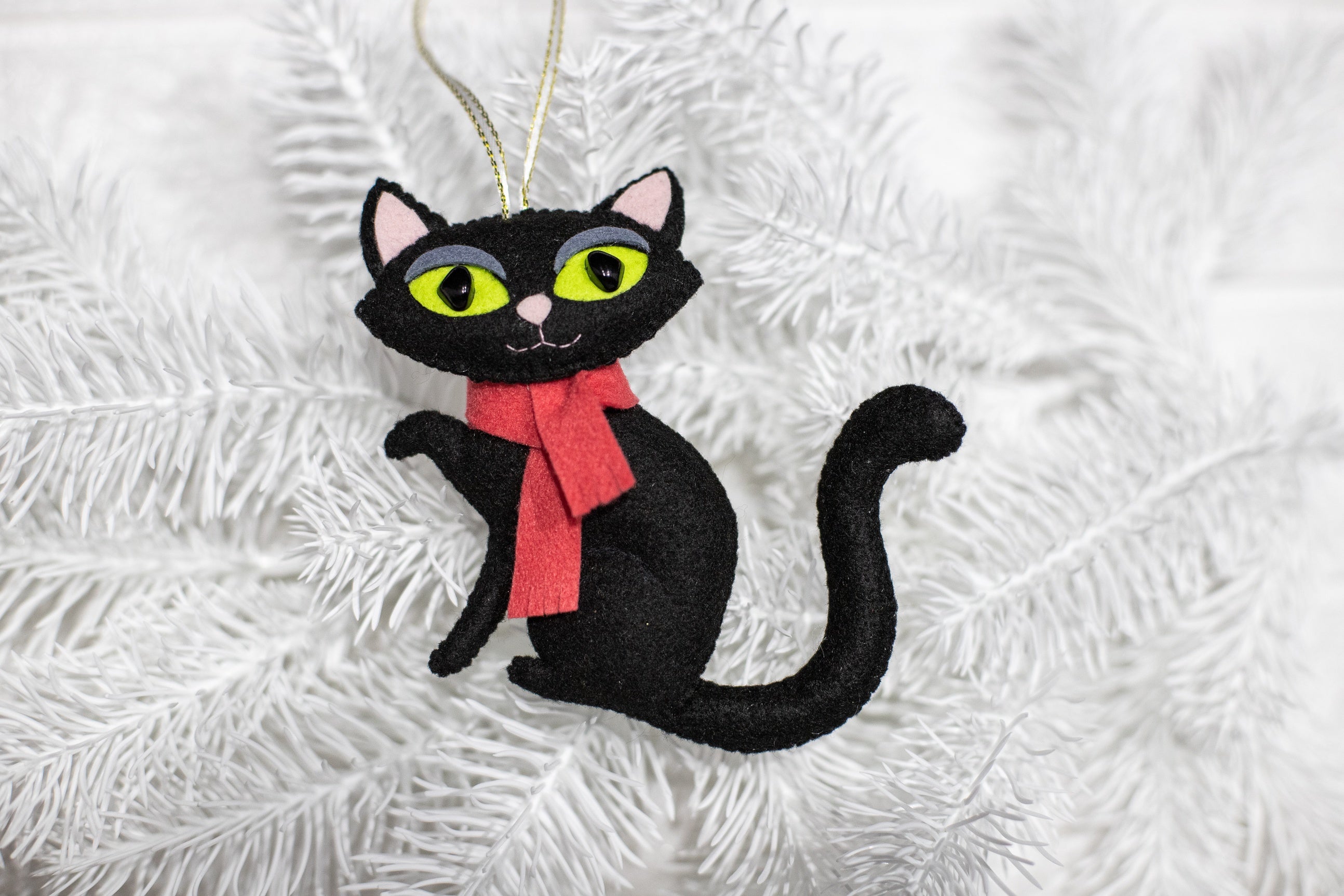 Felt black cat ornament, with big green eyes and der scarf